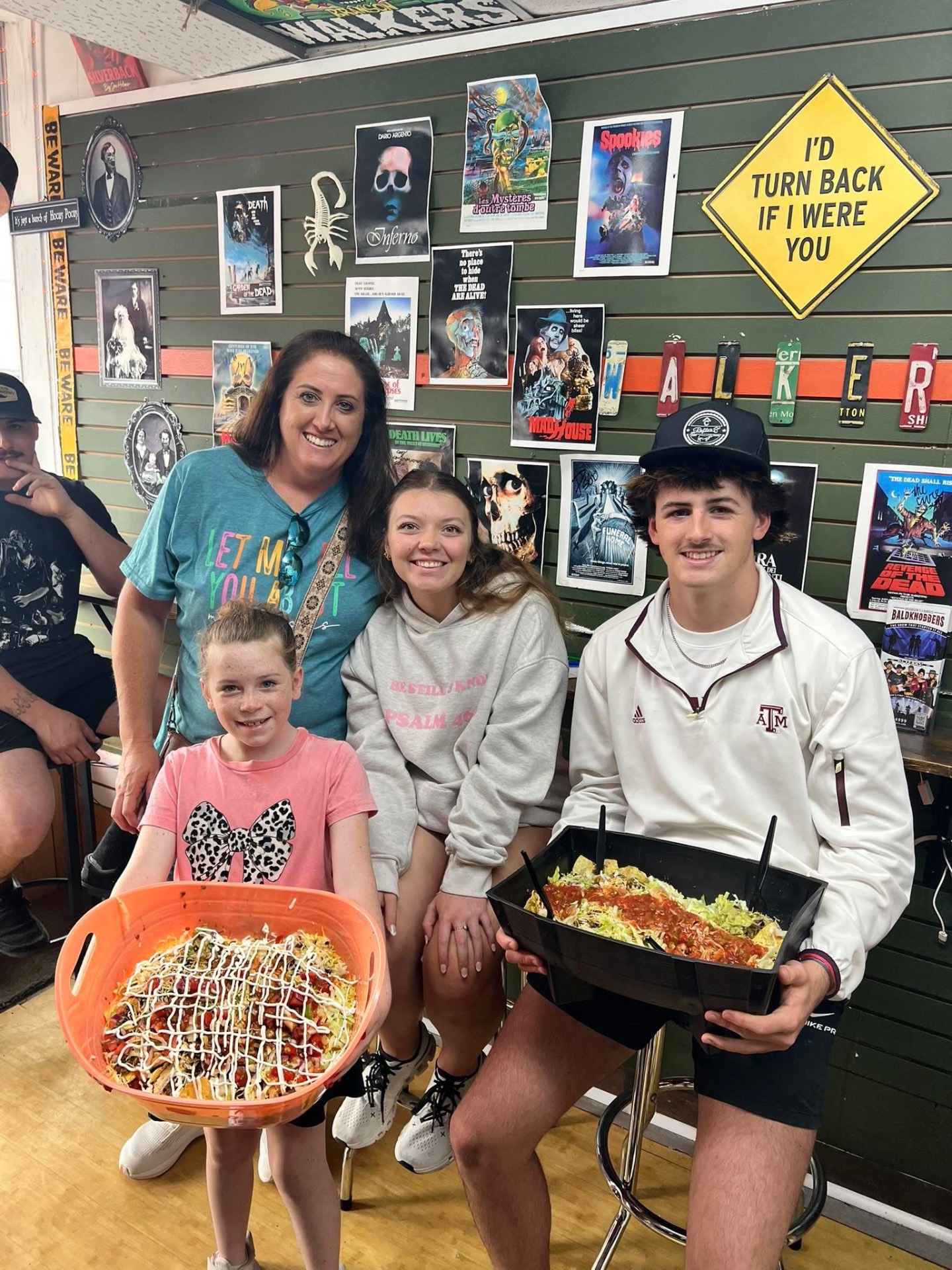 Family with loaded walking tacos in front of the Walkers horror wall
